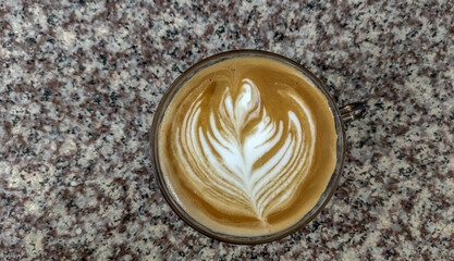 Hot latte coffee on marble table.