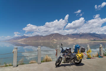 Touring motorcycle parking besides lake