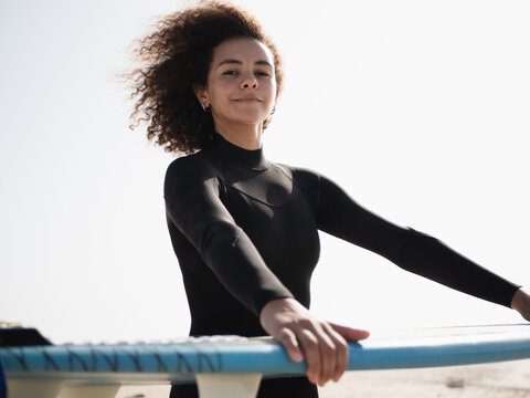 Young multiracial surfer female with afro hair portrait