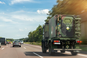 German armoured semi-trailer cargo truck carrier drives military convoy highway road. ALLIANCE...