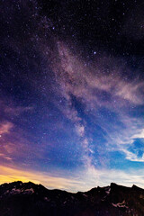 Milky Way, long exposure, the same ones shine in the sky with a frame of pine trees on the sides. Shooting stars crosses the night sky. © Why_Not