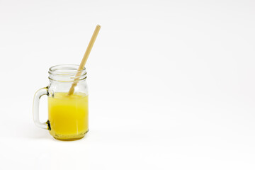 Bamboo straw in an orange juice glass