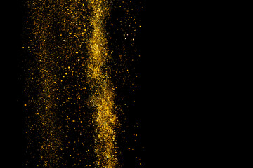 Gold glitter dust falling isolated on black background border design element with copy-space