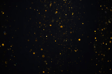 Golden glitter shimmer dust shiny lights particles dark abstract background