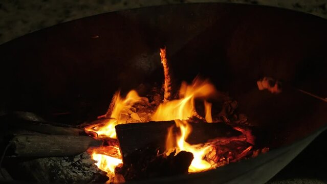 roating mashmallow candy on the firewood heat while camping in autumn winter time