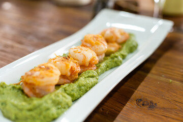 Prawns with garlic. Popular dish of Spanish cuisine. The ingredients are peeled prawns, garlic and olive oil. Served in clay pot They must be eaten quickly, without getting them to cool down.