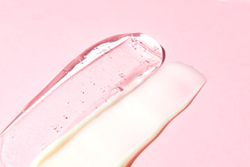 Gel and cream double texture swatch smear on pink background, transparent snail mucin serum skin...