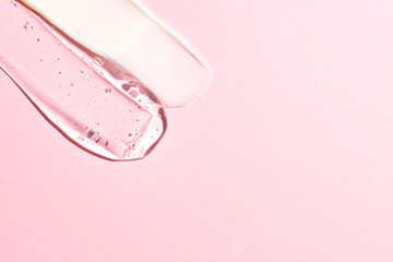 Various cosmetic mask, creams, serum, scrub and lotion smear on a pink background. Beauty texture. Sample of a cosmetic product. copy space for text
