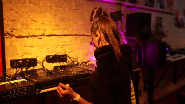 Beautiful female dancing to techno in a small club