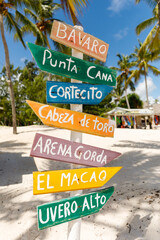 07.24.2022. Dominican Republic Bavaro Punta cana provinces La Altagracia. Wooden pillar with signposts directions - obrazy, fototapety, plakaty