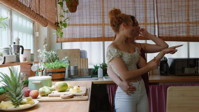 Cheerful lesbian couple in kitchen