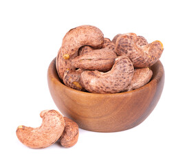 Cashew nuts in shell in wooden bowl, isolated on white background. Roasted and salted cashew nuts.
