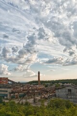 Fototapeta na wymiar Old industrial plant with a beautiful sky. Clouds swirl in the sky. Abandoned factory. High-quality photo