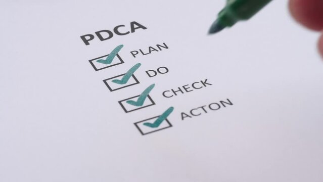 PDCA or PLAN, DO, CHECK, ACTION Business Management Concept. Businessman tick off or marking with green pen on checklist, checkbox after completing task on white paper. Selective focus 4K resolution