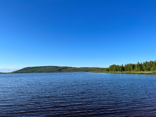 Calm lake view in the forest, blue sky