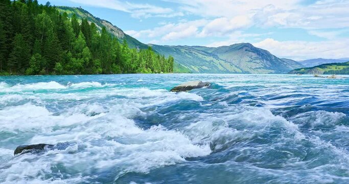 Flowing river and forest with mountain natural landscape in Kanas Scenic Area, Xinjiang, China.
