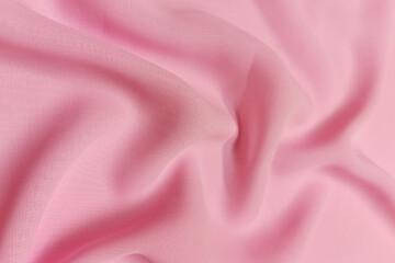 Pink chiffon fabric crumpled or wavy fabric texture background. Abstract linen cloth soft waves. Silk yarn. Smooth elegant luxury cloth texture. Concept for banner or advertisement.