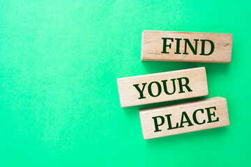 Find Your Place words on wooden blocks on green background.