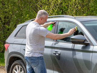 Young man washing the car with a sponge High quality photo
