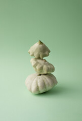 Pile of different squashes. Varieties and differences of shapes. Elegant minimal composition on mint green background.