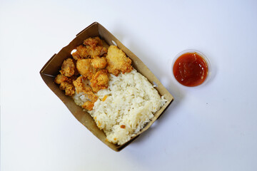 chicken popcorn and japanese rice in cardboard box on white background