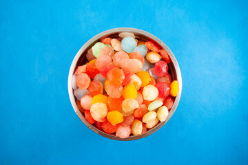 Frozen fruit juice in metal bowl. Multi Colored ice cubes. Rainbow ice for cocktail or summer...