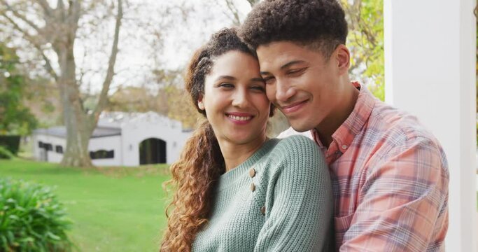 Video of smiling biracial couple spending time in the garden