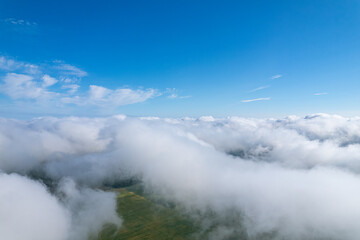 Fototapeta na wymiar Flying over beautiful fluffy clouds