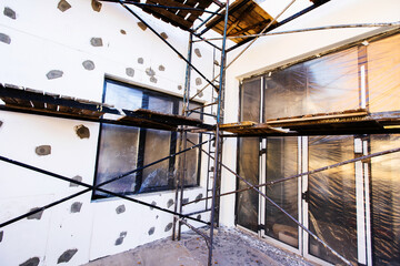 Insulation of a private house with foam panels. Installation of thermal insulation materials on the facade of the building. Close-up. selective focus