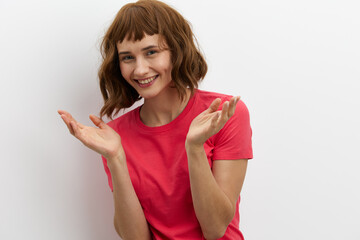 horizontal photo of a joyful, happy, laughing woman spreading her arms to the sides, standing on a white background with an empty space for inserting an advertising layout