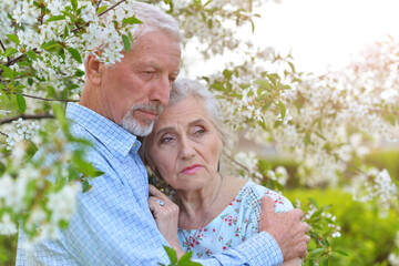 Portrait of sad senior couple at park