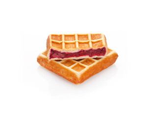 Freshly baked belgian waffles with red berry jam inside isolated on white background