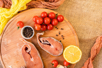  Raw red fish steaks on a wooden cutting board, ingredients for cooking. High quality photo