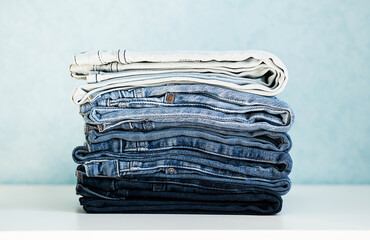 Some stacked blue jeans, close up. Denim collection.