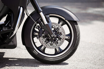 motorbike Front wheel and shock absorber close-up, outdoor on  street. bike riding. Sport rock lifestyle transport. Close up front wheel of a motorcycle.. Enjoying of freedom¨, power and local tourism