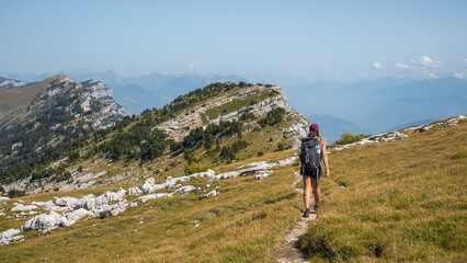 Woman hiking the Chartreuse moutains, in the French Alps, near the Dent de Crolles, Grenoble  - obrazy, fototapety, plakaty