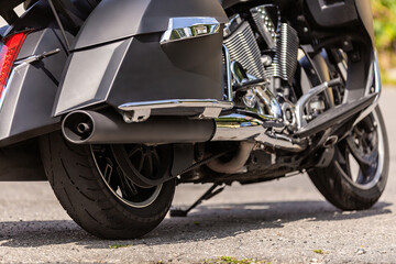 Fototapeta premium motorcycle wheel and transmission belt with lubrication close up, moto disc. outdoor on street. bike riding. Sport rock lifestyle transport. Close up front wheel of a motorcycle.. Enjoying of freedom