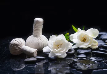 Poster Still life of with  gardenia, and spa ball , zen black stones on wet background  © Mee Ting