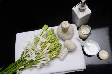 Lifestyle and Healthy Concept. Spa setting for massage treatment on black, background


