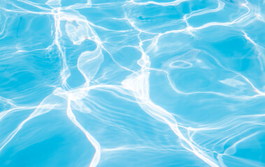 defocused beautiful bright photo with water pool texture windy sunny day,waves.different tones,color blue of water in day sun light.summer concept,vacation swim.hot warm heat days.beach sea travel