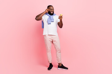 Full body photo of nice groomed man surfing in social media chatting with friends isolated on pink color background