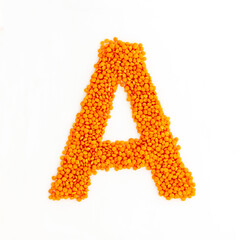 Capital letter A made from red lentils. Lentil font. White background. Bright font for menu or food blog. Lettering design element. Init cap