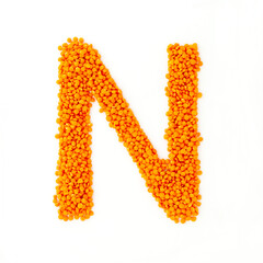 Capital letter N made from red lentils. Lentil font. White background. Bright font for menu or food blog. Lettering design element. Init cap