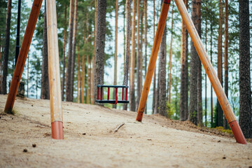 swings on empty playground in nature. Image with selective focus