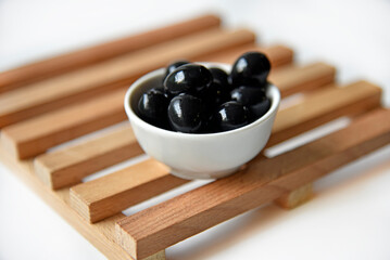 Black delicious fresh olives in a saucepan