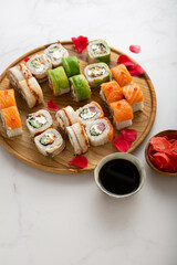 Fototapeta na wymiar Close up of sushi set with fish and avocado on plate
