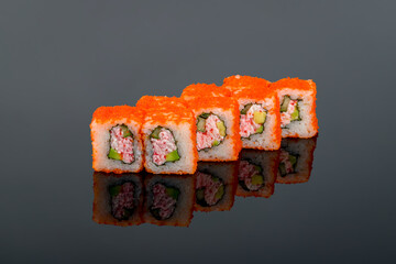 California roll with crab on black with reflection