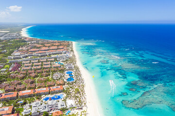 Bounty and pristine sandy shore with coconut palm trees, caribbean sea washes tropical coast. Arenda Gorda beach. Dominican Republic. Aerial view