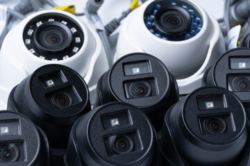 Modern white and black security cameras close up. Video surveillance concept background. selective focus