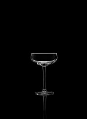 Empty glass for champagne or sparkling wine isolated on black background